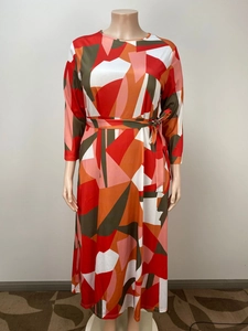 Detail of maxi dress featuring bold geometric prints and matching tie-waist belt