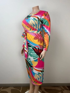 Detail of vibrant tropical leaf print maxi dress with long sleeves and a waist tie