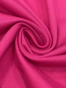Detail of rose pink knit fabric showing fine texture and soft draping quality