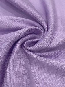 Close-up of soft lavender purple knit fabric with tight texture and elegant drape detail