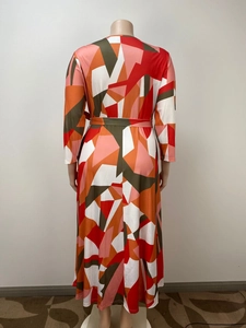Rear view of long sleeve maxi dress featuring abstract geometric color block print and waist tie