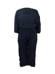 Detail of black popcorn fabric 3D texture on casual long sleeve top and pants set