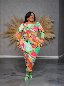Plus size long sleeve maxi dress featuring vibrant tropical floral print and waist tie