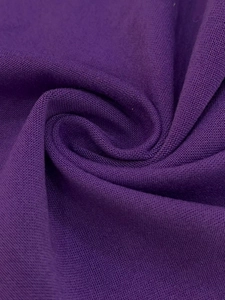 Detailed macro shot showing the fine texture and drape of the purple woven fabric