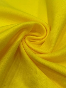 Macro shot of bright yellow knitted fabric showing detailed texture and soft drape