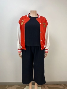 Detail of a red varsity jacket featuring green MOVE 19 embroidery and striped ribbed cuffs