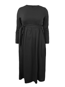Detail of high waist tie and vertical pleats on a black long-sleeve maxi dress