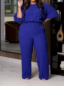 Women's royal blue two-piece set featuring short sleeve top and popcorn fabric wide leg pants