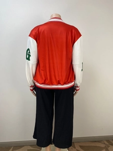 Detail of red varsity jacket back featuring white sleeves and striped ribbed cuffs