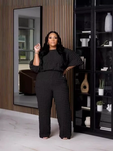 Women's black two-piece lounge set with bubble texture loose top and wide leg pants