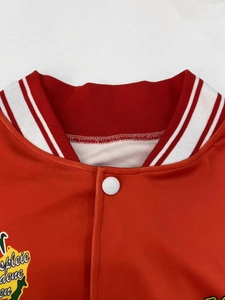 Detail of red varsity jacket collar with ribbed design and white snap button closure