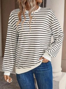 Detail of the crew neck and white ribbed cuffs on the black and white striped sweatshirt