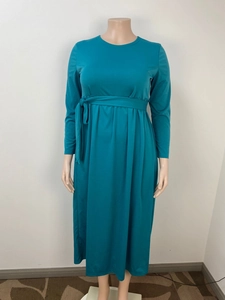 Detailed view of women long sleeve maxi dress with tie waist and pleated hem in dark teal
