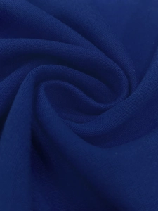Macro shot of navy blue knit fabric showing soft texture and premium drape detail