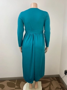 Back view of a teal long-sleeved maxi dress with cinched waist and pleated detail