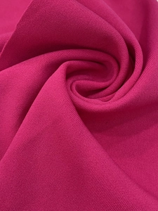 Close-up texture of soft rose red knitted fabric with high-quality weave detail