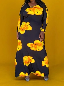 Plus size long sleeve maxi dress with vibrant yellow floral print on black background