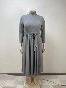 Detail view of the knitted fabric and adjustable tie-waist on this grey turtleneck dress
