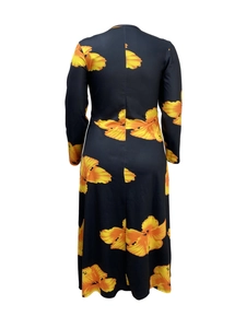 Detail view showing the back of a black long-sleeve maxi dress with large floral patterns