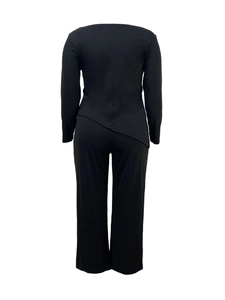Detail of black leisure set featuring asymmetric hem top and wide leg pants back view