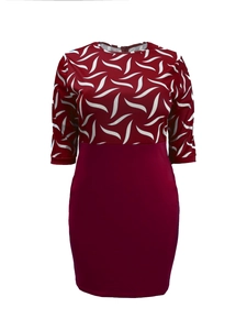 Close-up of white leaf print patterns on the burgundy bodice of a slim fit dress