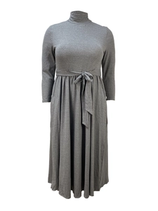 Detail of high neck long sleeve dress with self-tie waist belt and soft pleated knit texture