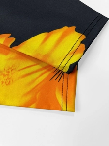 Detail of floral print on black fabric with reinforced double-needle stitching edges