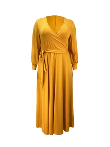 Detail of elegant mustard yellow V-neck maxi dress with waist belt and elastic cuffs