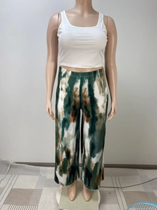 Detail of high waist elastic band and green tie-dye abstract print wide leg trousers