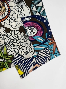 Detailed close-up of colorful abstract floral print fabric with fine stitching quality
