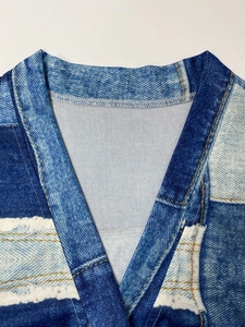 Detail of V-neckline with white overlock stitching on blue denim print midi dress