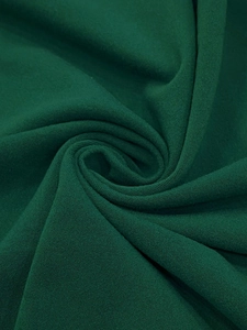Macro detail of dark green knit fabric texture showing fine weave and high-quality material