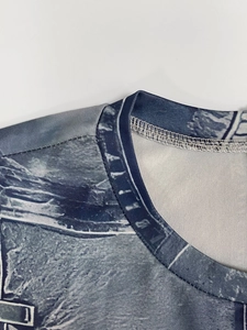Detail of crew neckline with reinforced stitching on tie-dye marble print dress