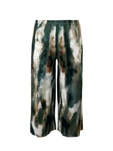 Detail of high-waist pleated wide-leg pants with abstract ink print and plissé texture