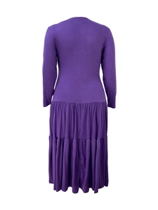 Detailed view of the purple tiered pleated dress with long sleeves and layered hemline