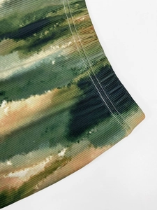 Detail view of vertical pleats and tie-dye pattern on relaxed fit street style trousers