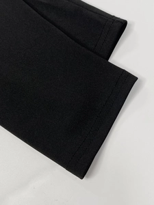 Macro detail of high-density black knit fabric with professional double-needle stitching