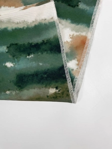 Detail of artistic abstract print on pleated fabric with high-quality stitching