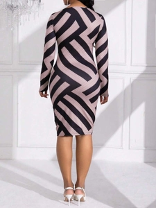 Bodycon midi dress with geometric purple and black stripes and long sleeves back view