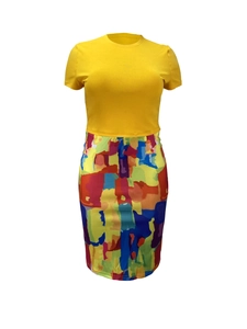 Detail of slim-fit two-piece dress with yellow knit top and colorful abstract print skirt