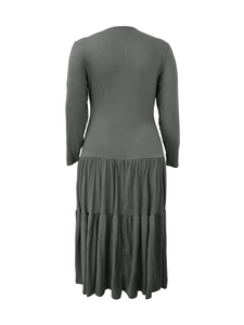 Detail of dark grey tiered pleated skirt hem and soft jersey fabric on midi dress