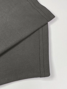 Detail of high-quality dark grey pleated knit fabric with durable double-needle stitching