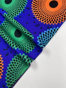 Detail view of bold polka dot print on high-elastic blue fabric with neat hem stitching