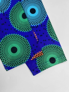Detailed view of royal blue geometric polka dot print sleeves with orange stitching