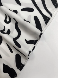 Close-up of black and white abstract print with precise single-needle stitching details
