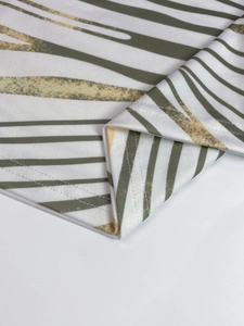 Detail view of double-needle hem and abstract striped print on high-density knit fabric