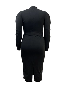 Detail view of the elegant black dress back with puff sleeves and a sleek back slit detail