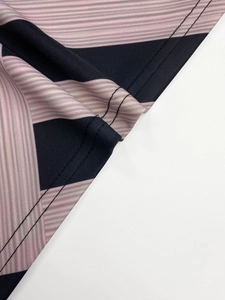 Detailed close-up of striped fabric stitching with fine ribbed texture on the dress