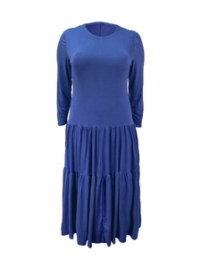 Detail of royal blue tiered pleated dress featuring a round neck and long sleeves
