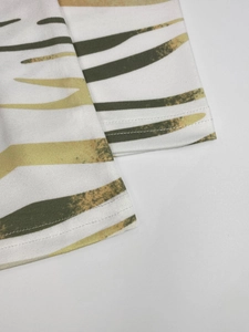 Detail of classic crew neck dress featuring abstract stripes and professional double stitching